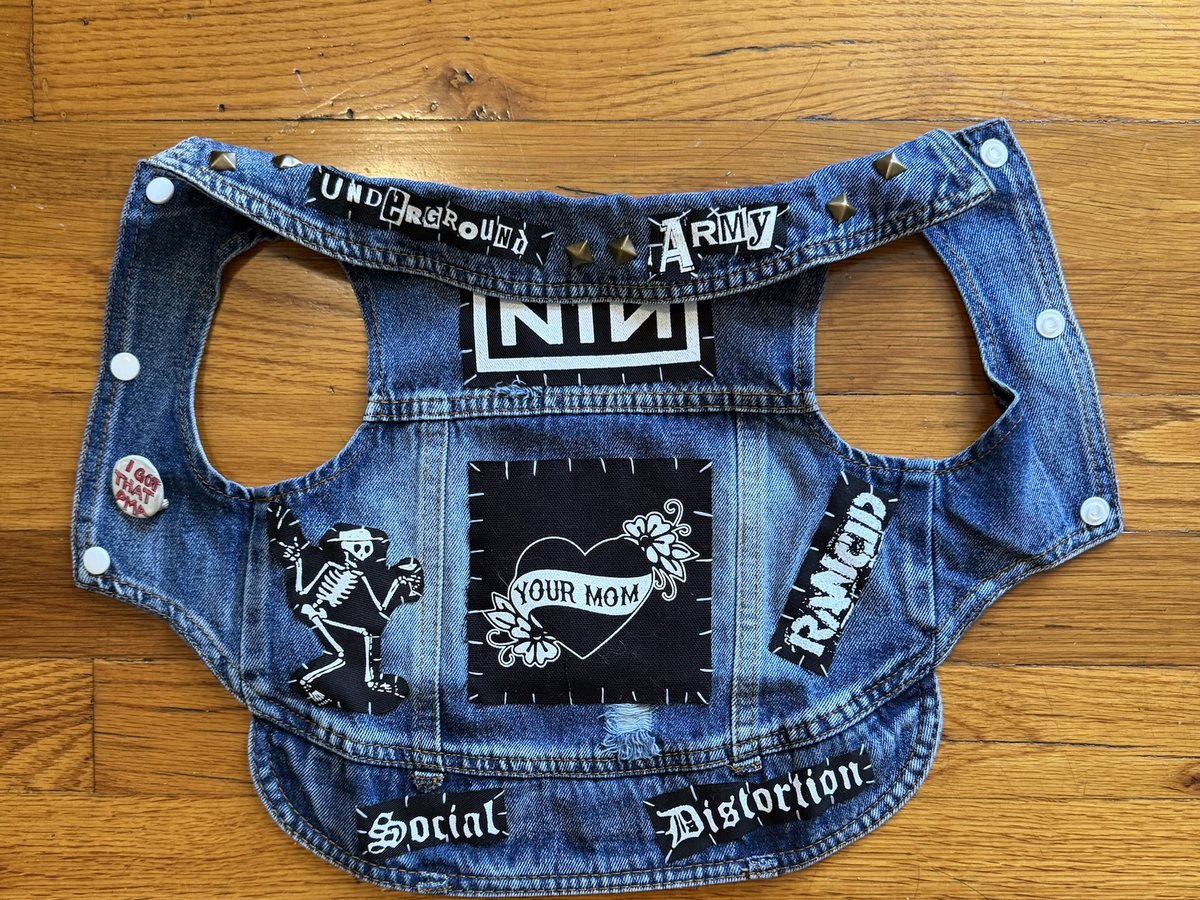 The Your Mom vest laid flat: plain denim with a Your Mom heart back patch, a Nine Inch Nails patch, an Underground Army strip and brass studs at the collar, a Social Distortion skeleton, a Rancid strip, Social Distortion strips across the hem and an I Got That PMA pin