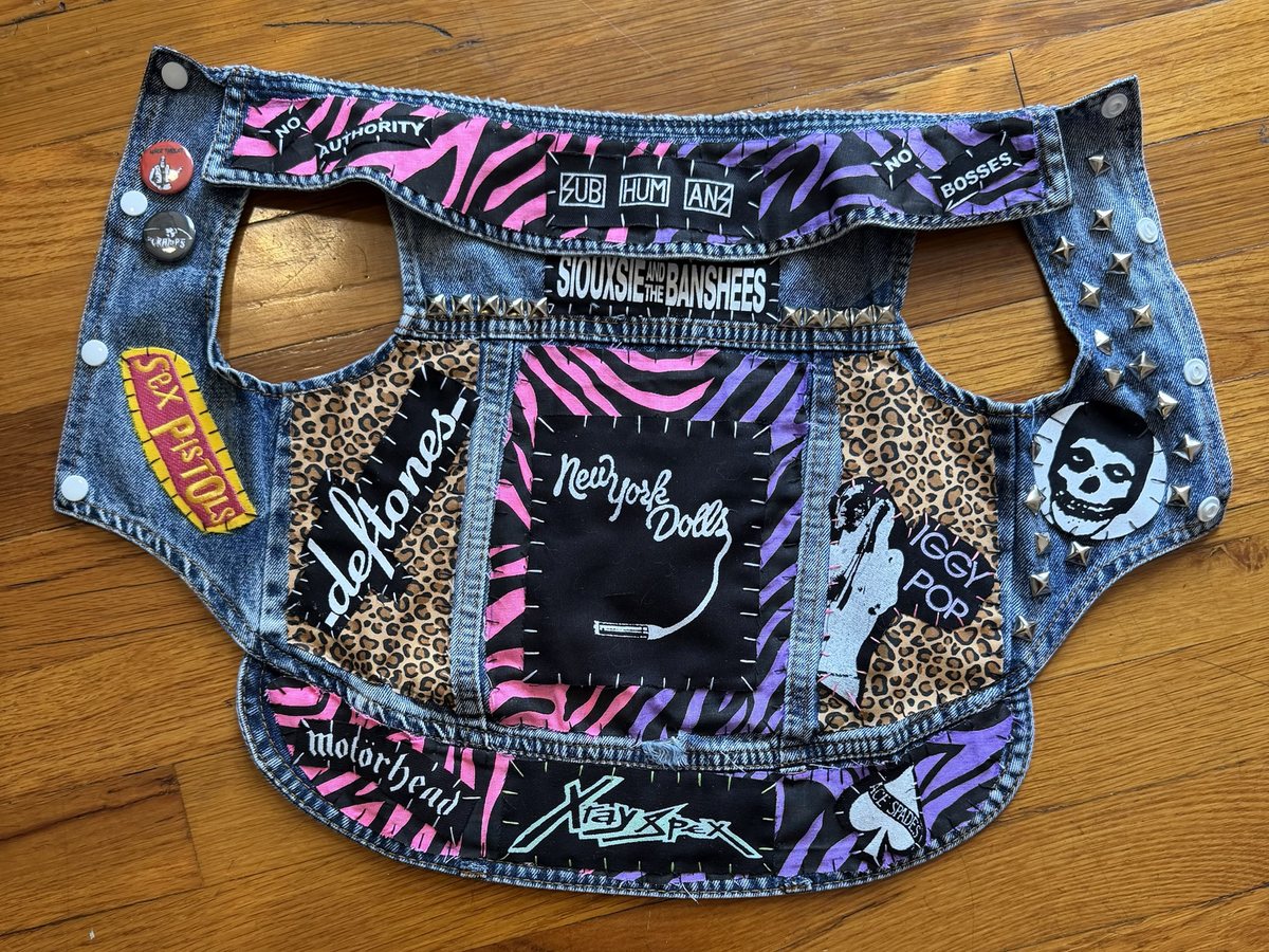 The Smoke Show vest laid flat: a New York Dolls back patch on pink and purple zebra print, leopard-print side panels with Deftones and Iggy Pop patches, a zebra-print collar with No Authority, Subhumans and No Bosses strips, a Siouxsie and the Banshees strip, Sex Pistols and Misfits patches, Motorhead, X-Ray Spex and Ace of Spades across the hem, chrome studs and pins