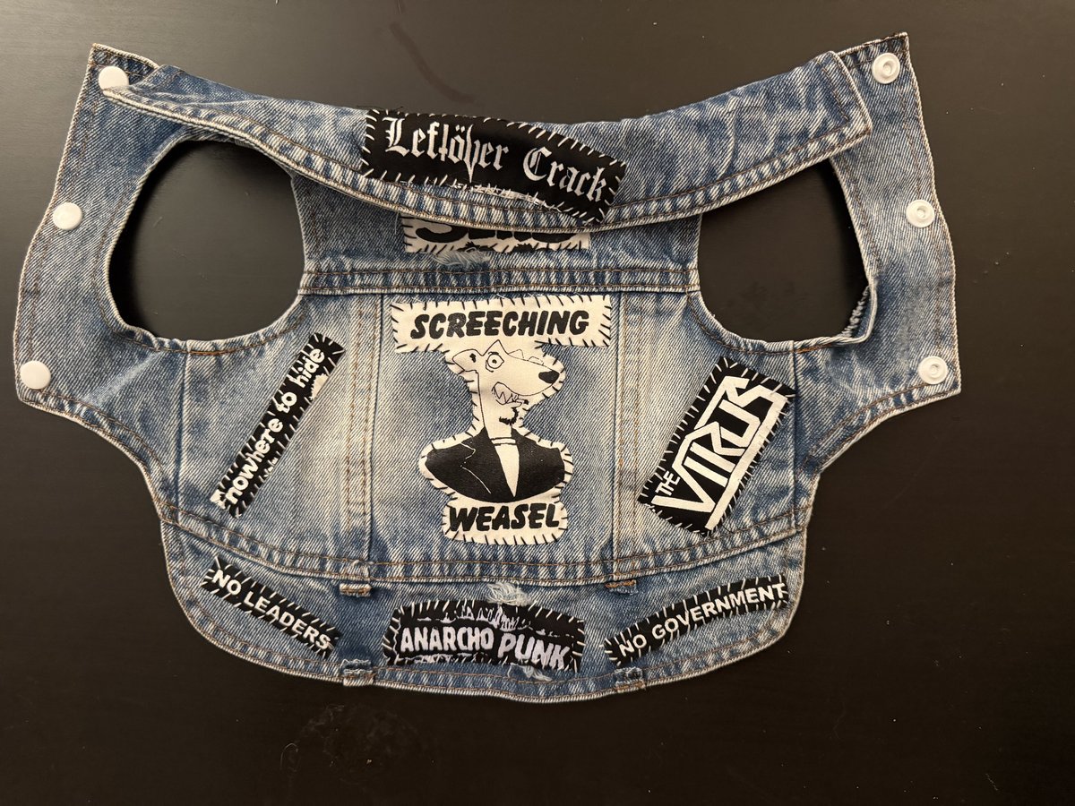 The Crack This vest laid flat: light denim with a Leftover Crack strip on the collar, The Slits under it, a Screeching Weasel back patch, Nowhere to Hide and The Virus on the sides, and No Leaders, Anarcho Punk and No Government across the hem, white snaps